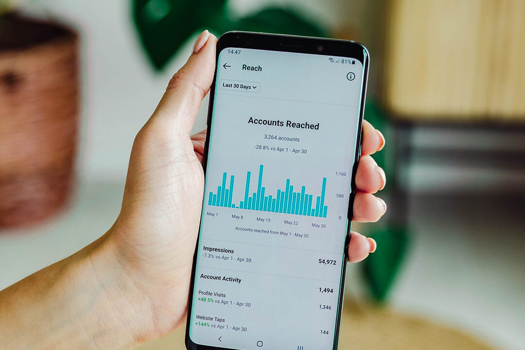 photo of mobile phone showing graph of audience reach