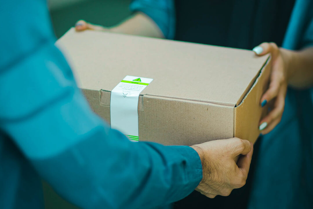 delivery guy handing over box to customer